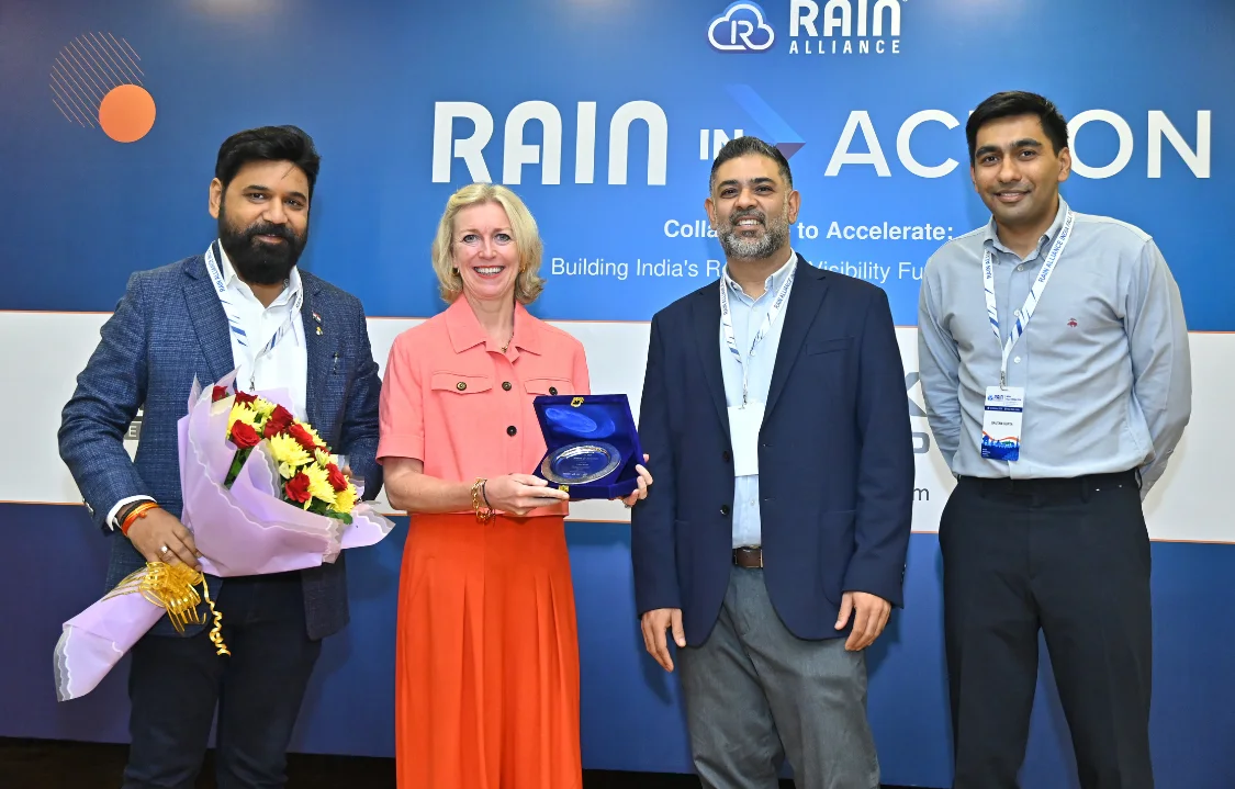 Aileen Ryan receiving a commemorative memento with Ashim Ashok Patil and RAIN in Action representatives in New Delhi.